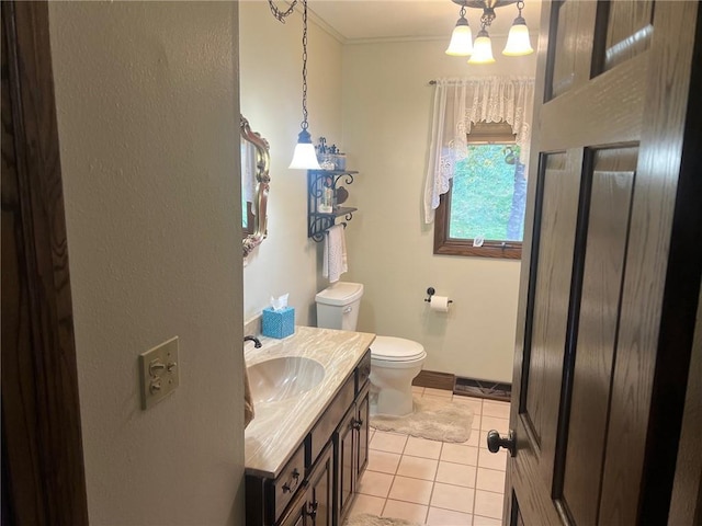 bathroom featuring vanity, tile patterned flooring, and toilet