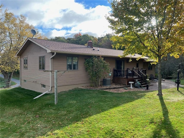 rear view of property with cooling unit, a yard, and a deck