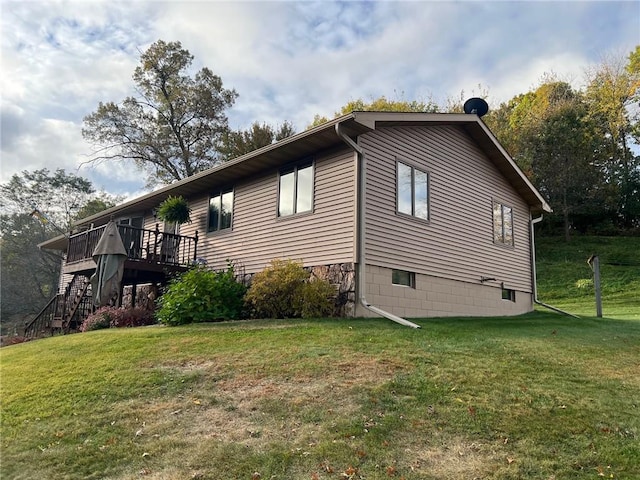 view of home's exterior featuring a yard and a wooden deck