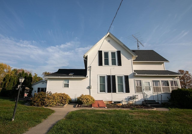 back of property featuring a lawn