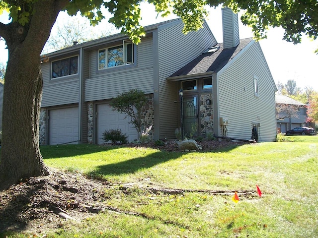 view of front of home featuring a garage and a front lawn