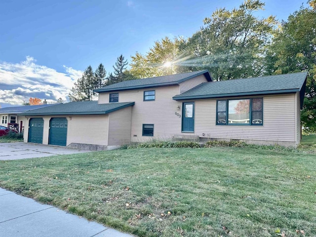 tri-level home with a front lawn and a garage