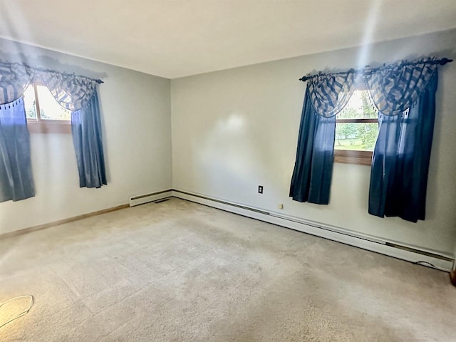 empty room featuring a wealth of natural light and baseboard heating