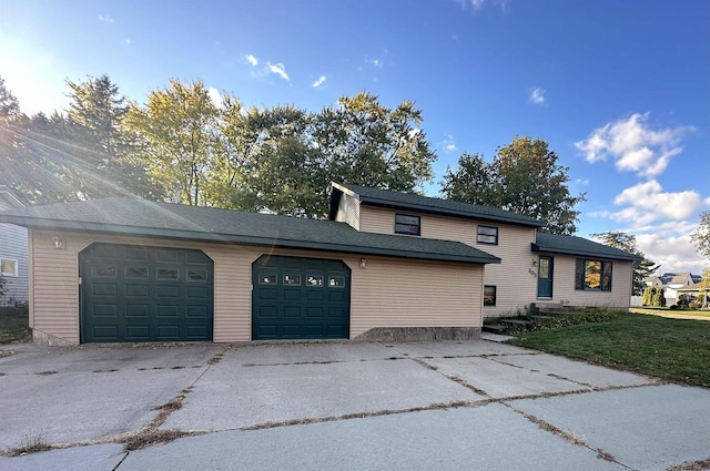 view of front property with a front yard and a garage