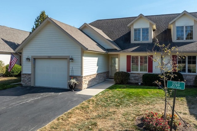 view of front of house with a front yard and a garage