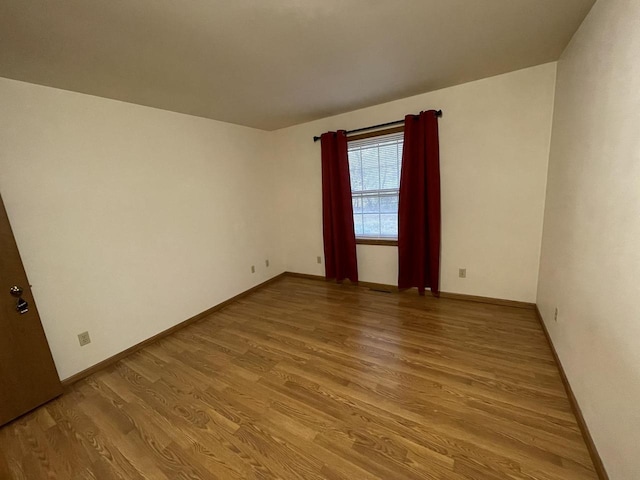 unfurnished room with light wood-type flooring