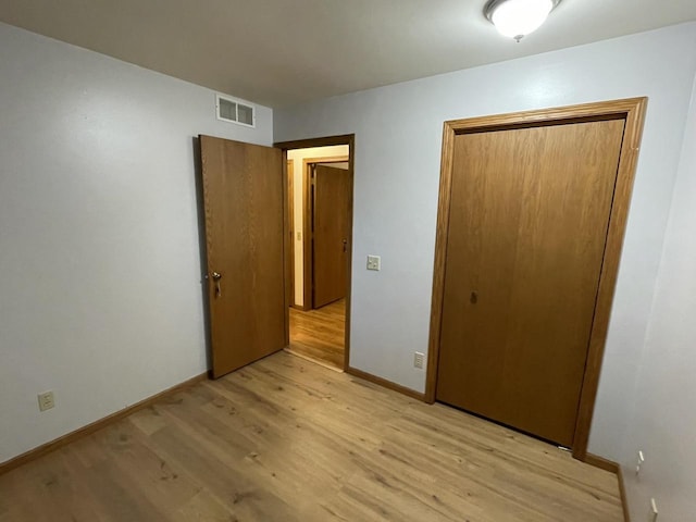 unfurnished bedroom featuring light wood-type flooring