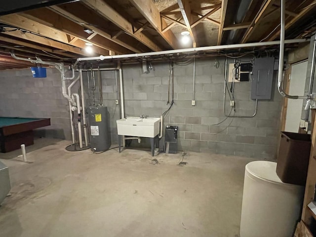 basement featuring electric panel, pool table, water heater, and sink