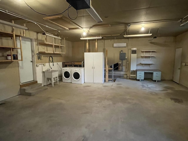 garage with washer and clothes dryer and a garage door opener