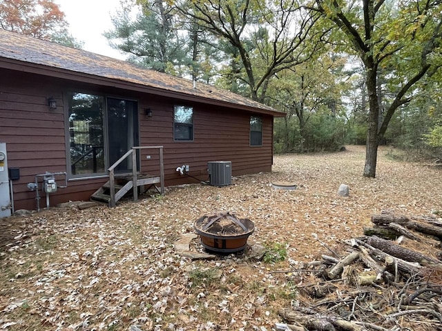 exterior space featuring an outdoor fire pit and central AC