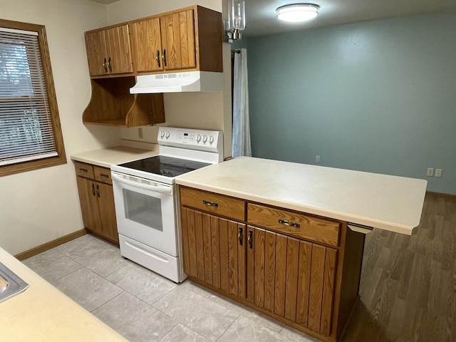 kitchen with white electric range oven and light wood-type flooring