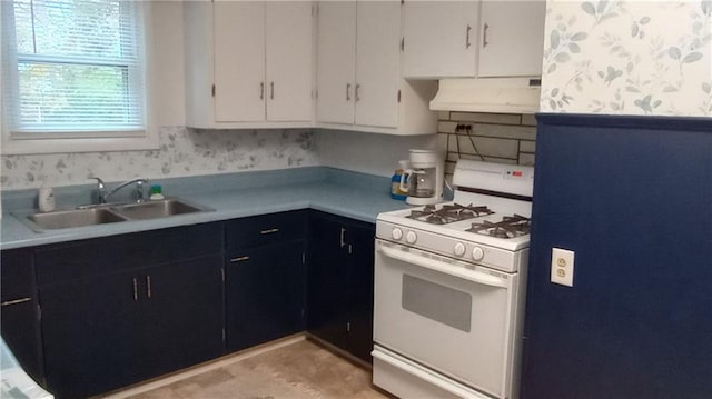 kitchen with white cabinetry, gas range gas stove, and sink