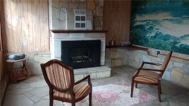 sitting room with a stone fireplace