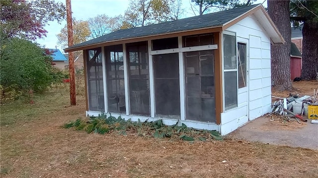 view of outbuilding featuring a sunroom