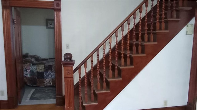 staircase with hardwood / wood-style flooring