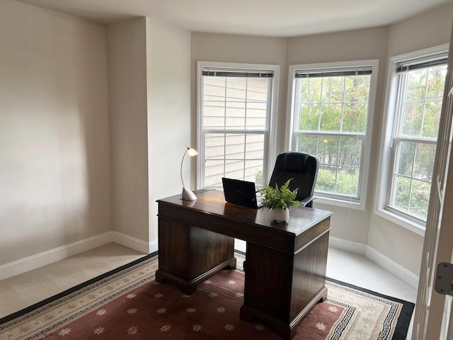 carpeted home office with a healthy amount of sunlight