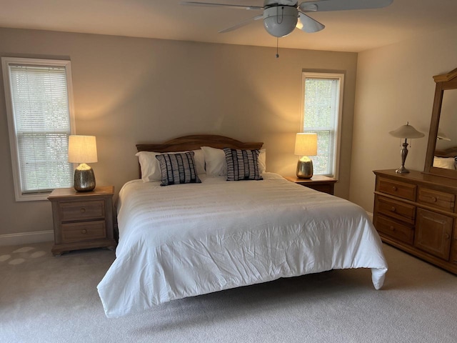 bedroom with ceiling fan and light colored carpet