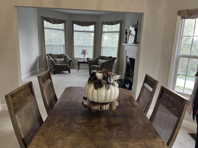 carpeted dining space featuring a healthy amount of sunlight