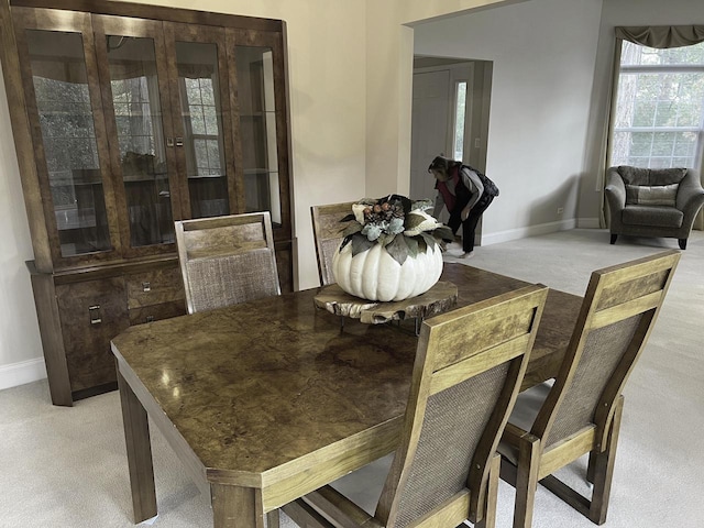 dining area with light colored carpet