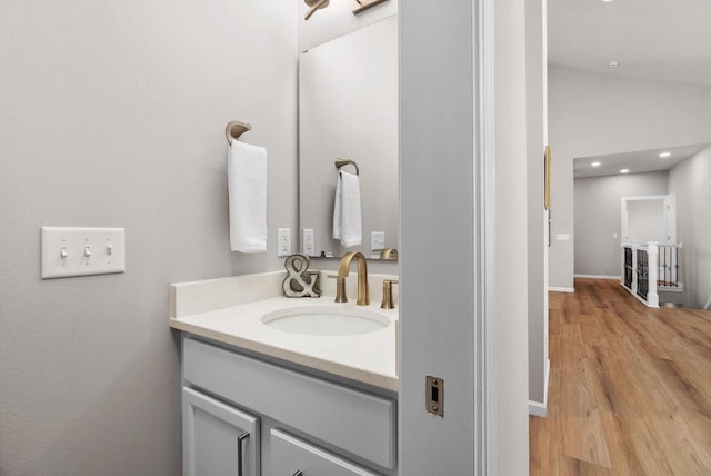 2352 Lonnie Ct, Sun Prairie, WI 53590 - bathroom with vanity, wood finished floors, recessed lighting, and vaulted ceiling