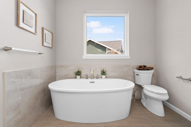 2352 Lonnie Ct, Sun Prairie, WI 53590 - bathroom with a freestanding bath, toilet, tile walls, and tile patterned floors