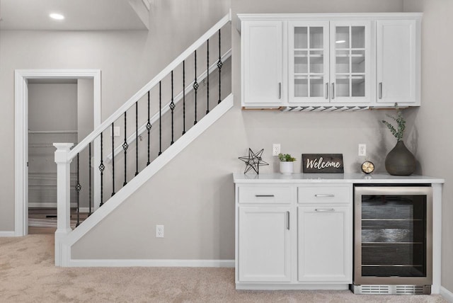 2352 Lonnie Ct, Sun Prairie, WI 53590 - indoor dry bar featuring wine cooler, stairs, carpet floors, baseboards, and recessed lighting