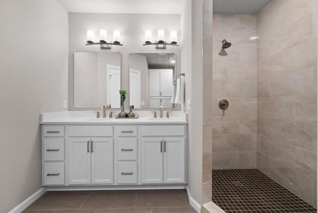 2352 Lonnie Ct, Sun Prairie, WI 53590 - bathroom featuring walk in shower, double vanity, tile patterned floors, and baseboards