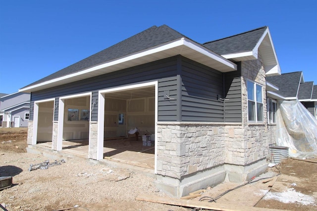 2352 Lonnie Ct, Sun Prairie, WI 53590 - view of side of home with stone siding and a shingled roof