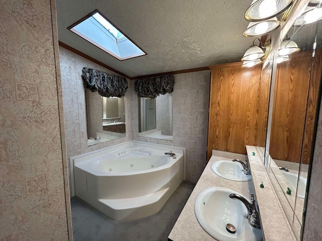 bathroom featuring vanity, ornamental molding, a textured ceiling, a tub to relax in, and lofted ceiling with skylight