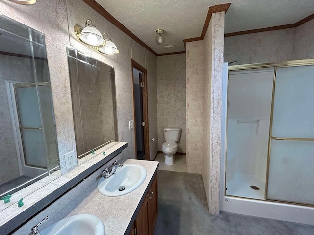 bathroom with crown molding, a shower with shower door, vanity, and toilet