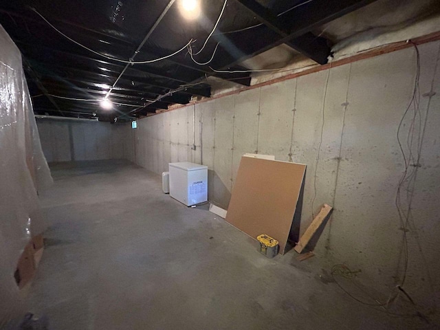 basement with white refrigerator