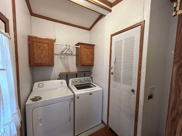 laundry area with crown molding, separate washer and dryer, and cabinets