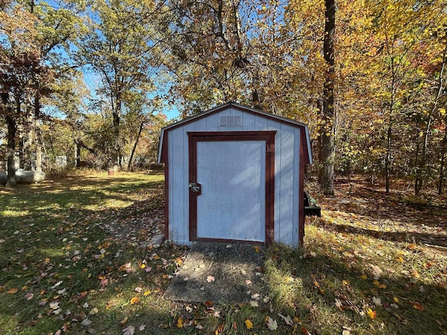 view of outbuilding with a yard