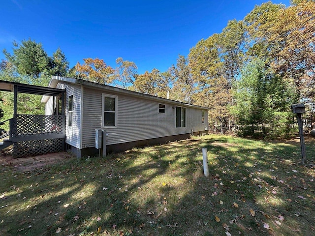 rear view of property featuring a lawn