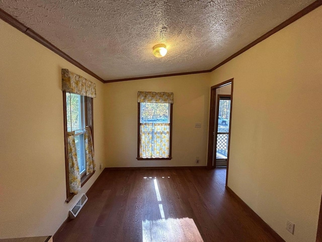 unfurnished room with ornamental molding, dark wood-type flooring, and a textured ceiling