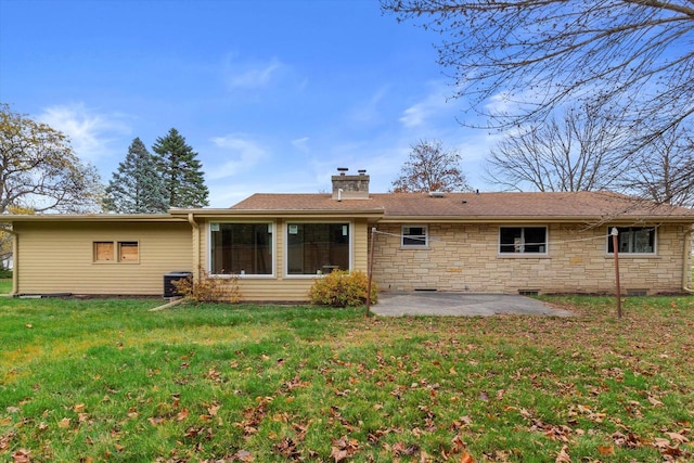 rear view of property featuring a patio and a yard