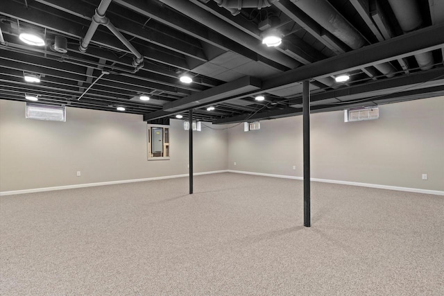 basement with electric panel and carpet flooring