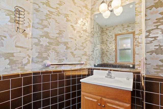 bathroom featuring vanity and tile walls