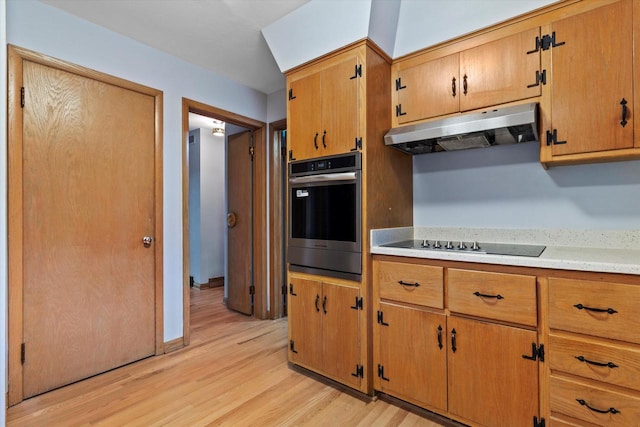 kitchen featuring light hardwood / wood-style flooring, black electric cooktop, and stainless steel oven