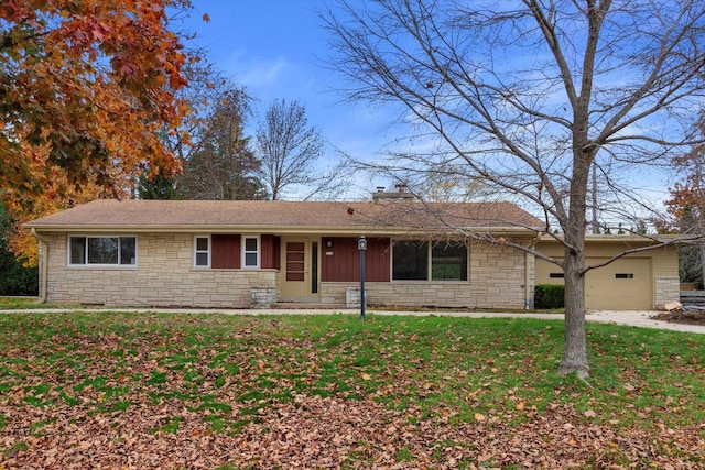 ranch-style home with a garage and a front yard