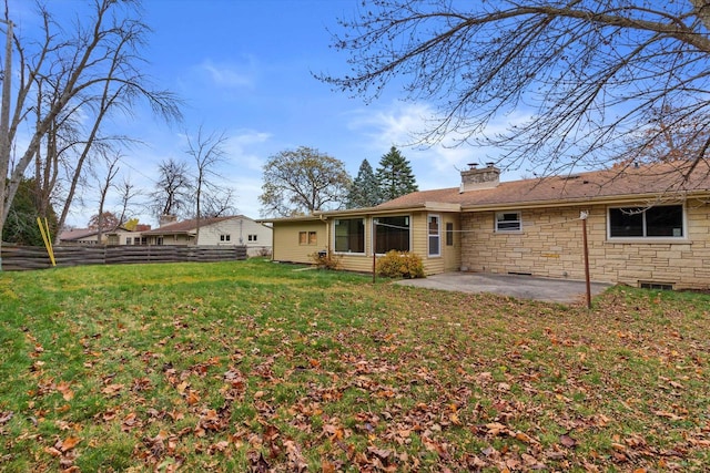 rear view of house featuring a patio area and a lawn