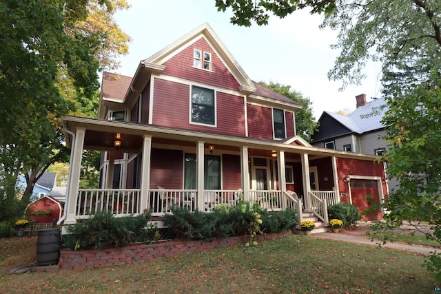 view of front facade with a porch and a garage