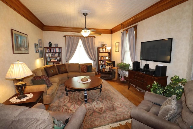 living room featuring ceiling fan, wood-type flooring, and ornamental molding