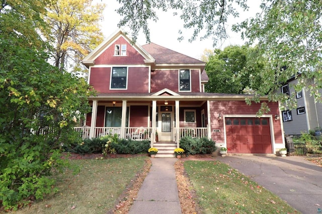 view of front of property featuring a garage and a porch