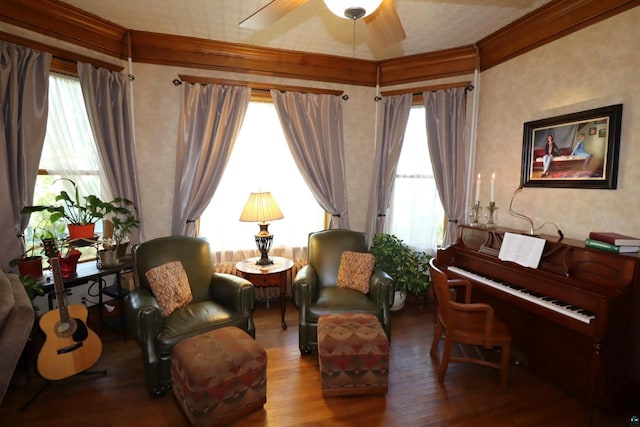 living area with a healthy amount of sunlight, ornamental molding, and hardwood / wood-style flooring