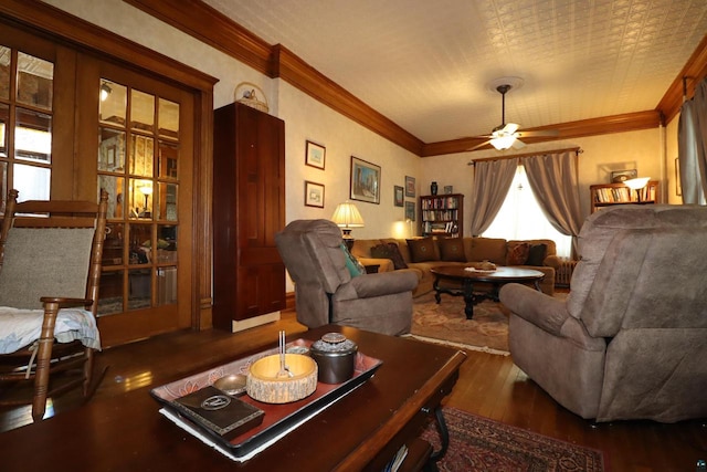 living room with ceiling fan, dark hardwood / wood-style flooring, and ornamental molding