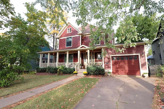 view of front of property with covered porch and a garage