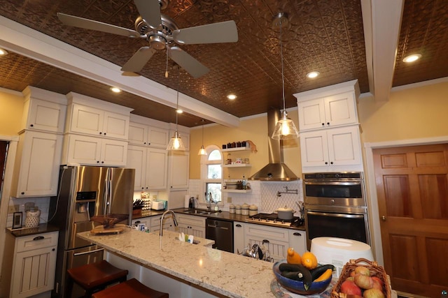 kitchen with ceiling fan, appliances with stainless steel finishes, decorative backsplash, a kitchen breakfast bar, and dark stone countertops