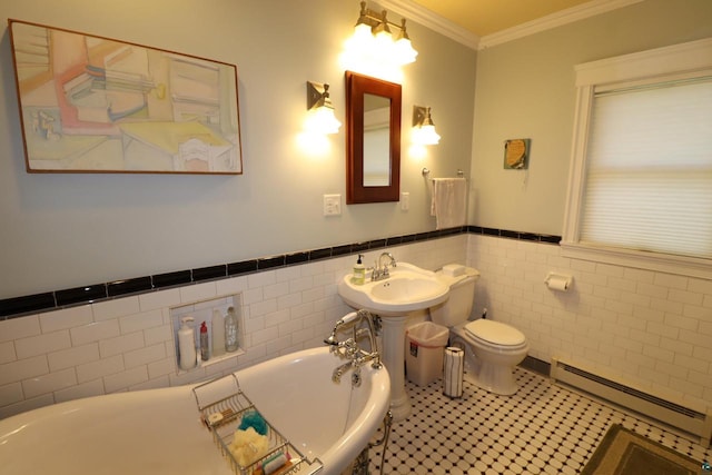 bathroom with tile patterned flooring, a baseboard heating unit, tile walls, a bathtub, and crown molding