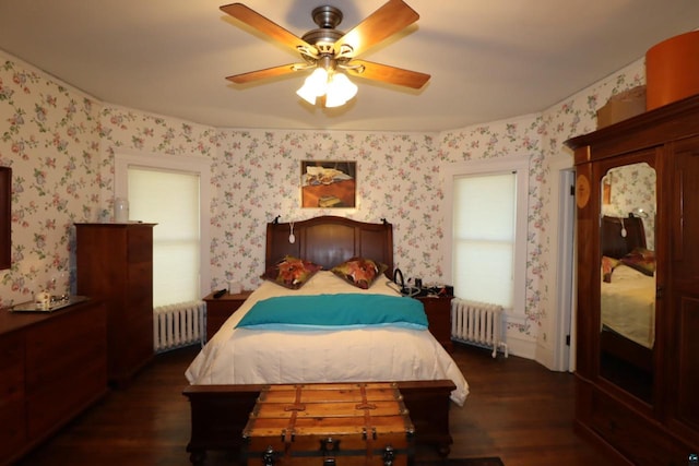 bedroom with ceiling fan, dark hardwood / wood-style floors, and radiator